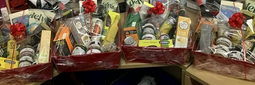 Churston hampers packed with local produce, wrapped and tied with red bows, ready for collection