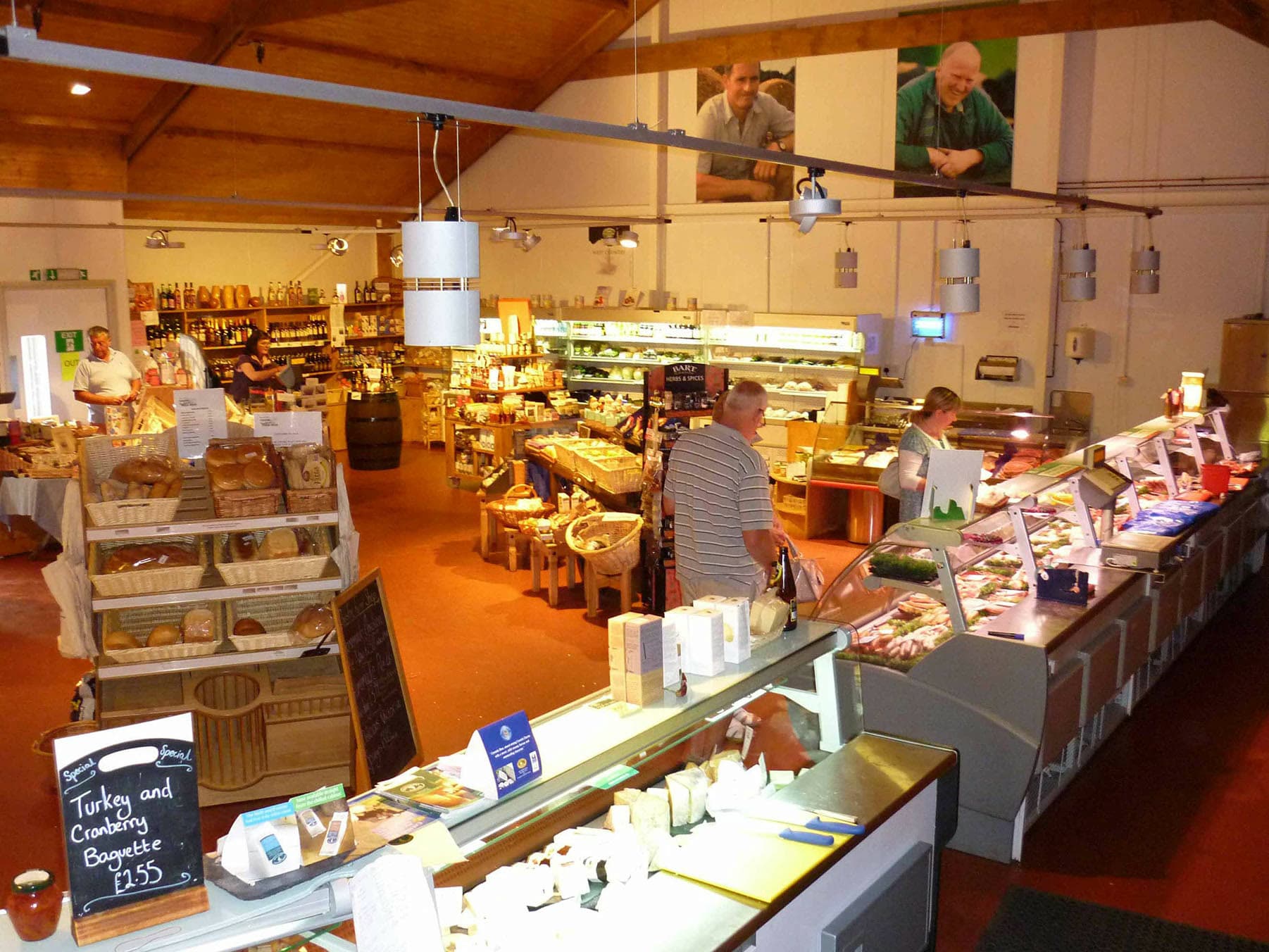 Bread baskets, cheese counter and the long meat counter inside Churston Traditional Farm Shop